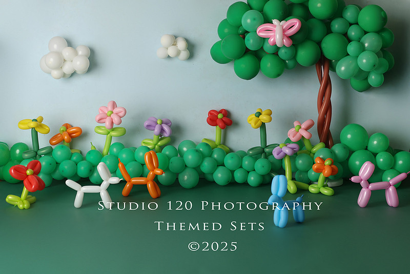 Creative two-year-old birthday portrait session styled as an art-inspired balloon garden with playful florals and sculptural details