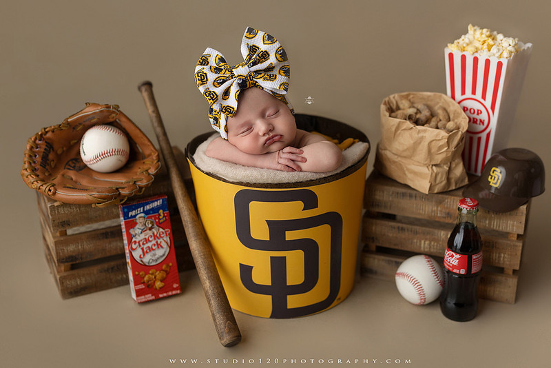“newborn baby baseball photo with miniature bat and glove props”
“baseball themed newborn photography with baby and ball rustic sports setup”
“infant portrait styled with baseball, glove, and classic sports memorabilia”