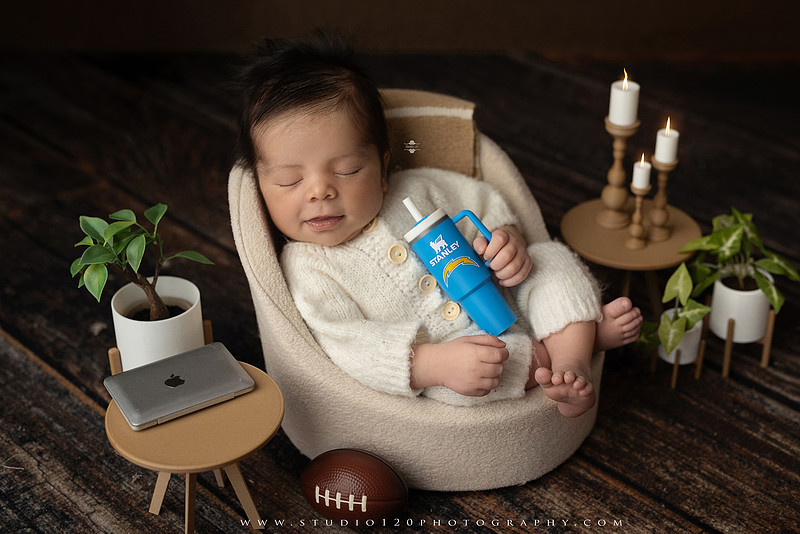 “newborn baby football themed photo with mini football and green turf backdrop”
“adorable infant posed with football props celebrating Super Bowl 2026 newborn session”
“sports baby photography football style end zone setup newborn portrait”