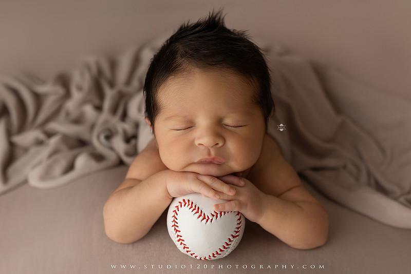 “newborn baby baseball photo with miniature bat and glove props”
“baseball themed newborn photography with baby and ball rustic sports setup”
“infant portrait styled with baseball, glove, and classic sports memorabilia”