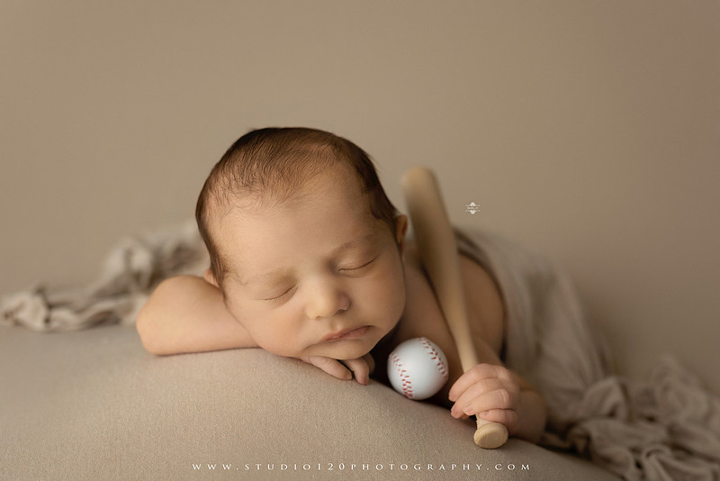 “newborn baby baseball photo with miniature bat and glove props”
“baseball themed newborn photography with baby and ball rustic sports setup”
“infant portrait styled with baseball, glove, and classic sports memorabilia”