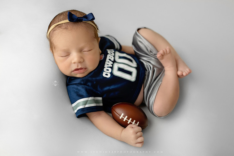 “newborn baby football themed photo with mini football and green turf backdrop”
“adorable infant posed with football props celebrating Super Bowl 2026 newborn session”
“sports baby photography football style end zone setup newborn portrait”