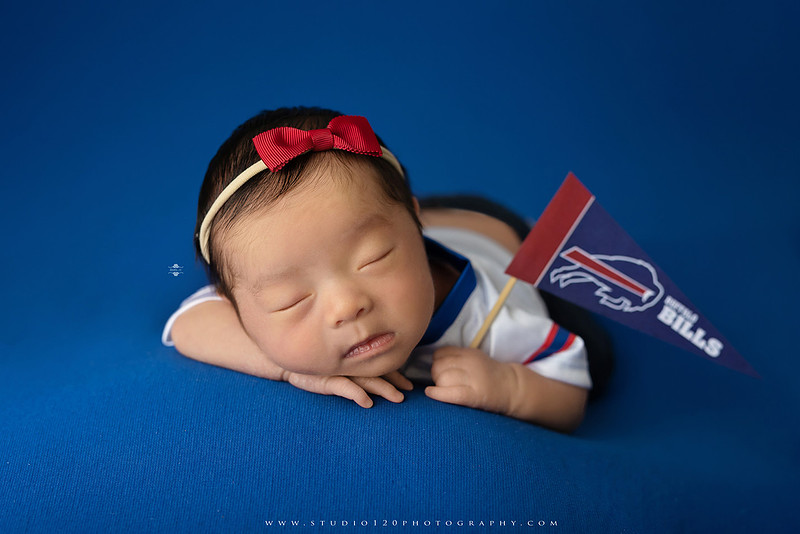 “newborn baby football themed photo with mini football and green turf backdrop”
“adorable infant posed with football props celebrating Super Bowl 2026 newborn session”
“sports baby photography football style end zone setup newborn portrait”