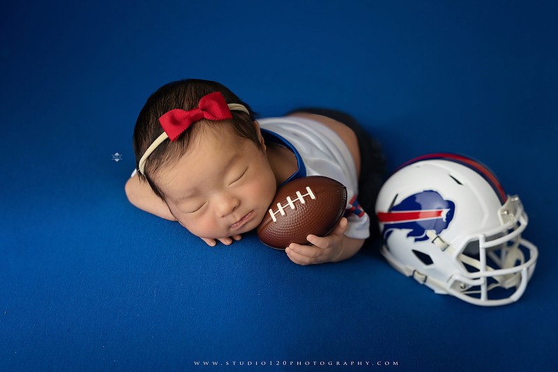 “newborn baby football themed photo with mini football and green turf backdrop”
“adorable infant posed with football props celebrating Super Bowl 2026 newborn session”
“sports baby photography football style end zone setup newborn portrait”