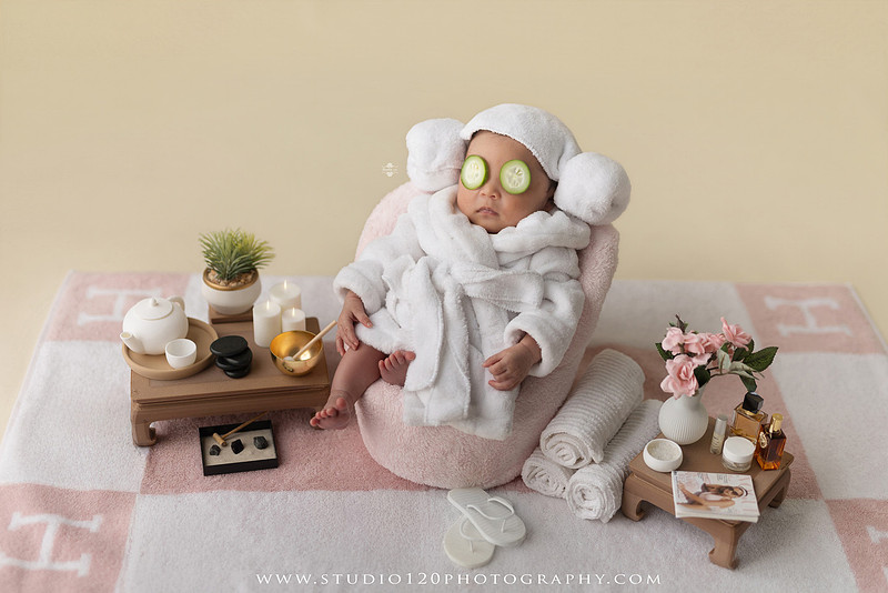 Hermès inspired newborn photography featuring baby girl posed in luxury orange gift box setup at Studio 120 Photography in San Diego County.