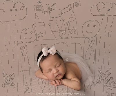 Hermès inspired newborn photography featuring baby girl posed in luxury orange gift box setup at Studio 120 Photography in San Diego County.