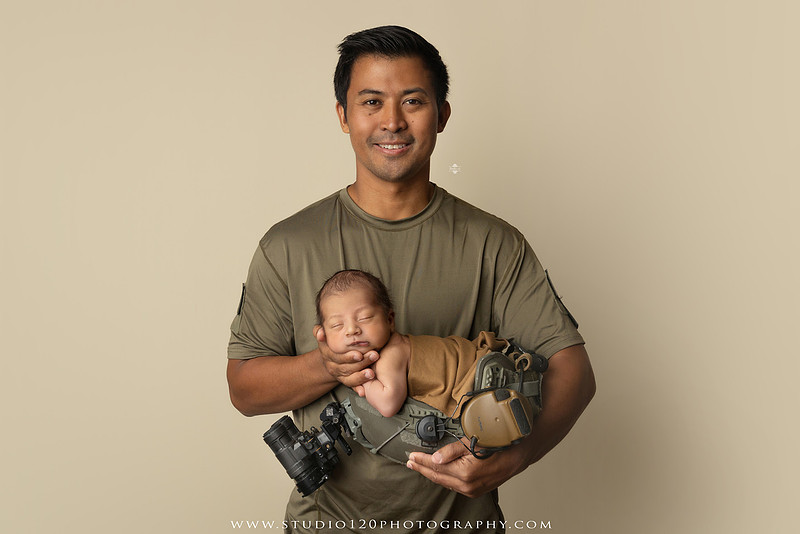 Parents cuddling their newborn baby boy during a family portrait session at Studio 120 Photography.