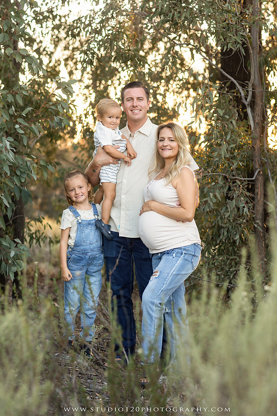 Outdoor maternity photography session in Ramona, CA featuring an expectant mother, father, and young children during golden hour with natural family portraits, pregnancy photos, and scenic Southern California landscapes by Studio 120 Photography.