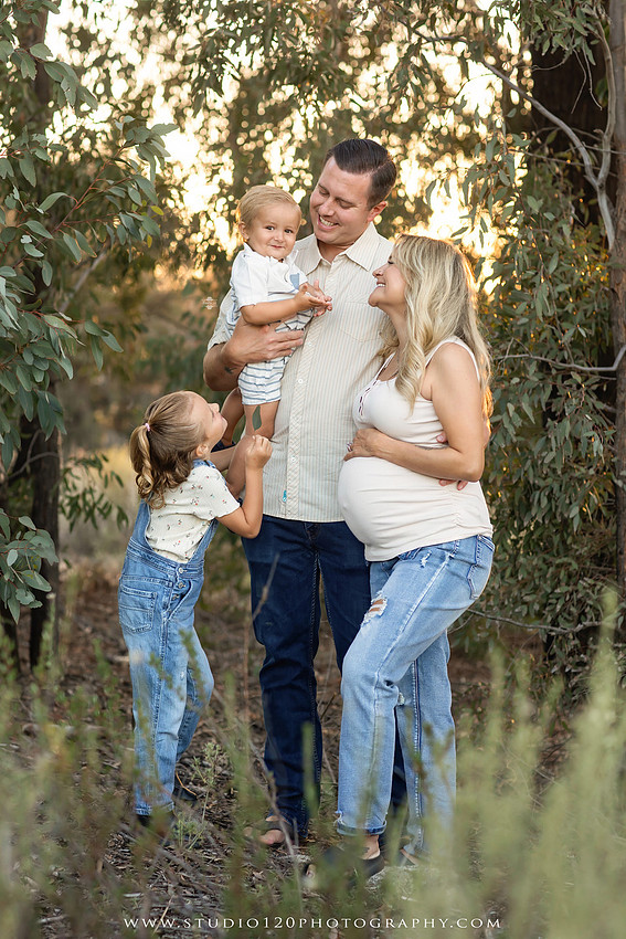 Outdoor maternity photography session in Ramona, CA featuring an expectant mother, father, and young children during golden hour with natural family portraits, pregnancy photos, and scenic Southern California landscapes by Studio 120 Photography.