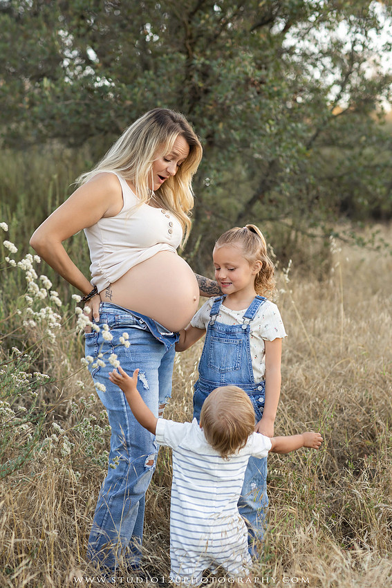 Outdoor maternity photography session in Ramona, CA featuring an expectant mother, father, and young children during golden hour with natural family portraits, pregnancy photos, and scenic Southern California landscapes by Studio 120 Photography.