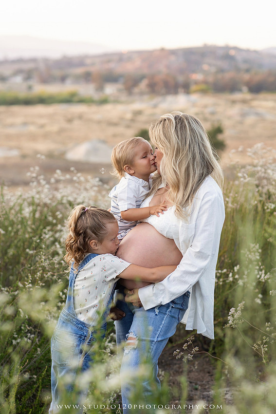 Outdoor maternity photography session in Ramona, CA featuring an expectant mother, father, and young children during golden hour with natural family portraits, pregnancy photos, and scenic Southern California landscapes by Studio 120 Photography.
