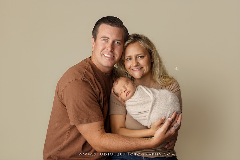 Professional newborn photography session in Ramona featuring a sleeping baby boy, sibling portraits, loving family photos, timeless neutral styling, wrapped newborn poses, and classic studio portraits by Studio 120 Photography.