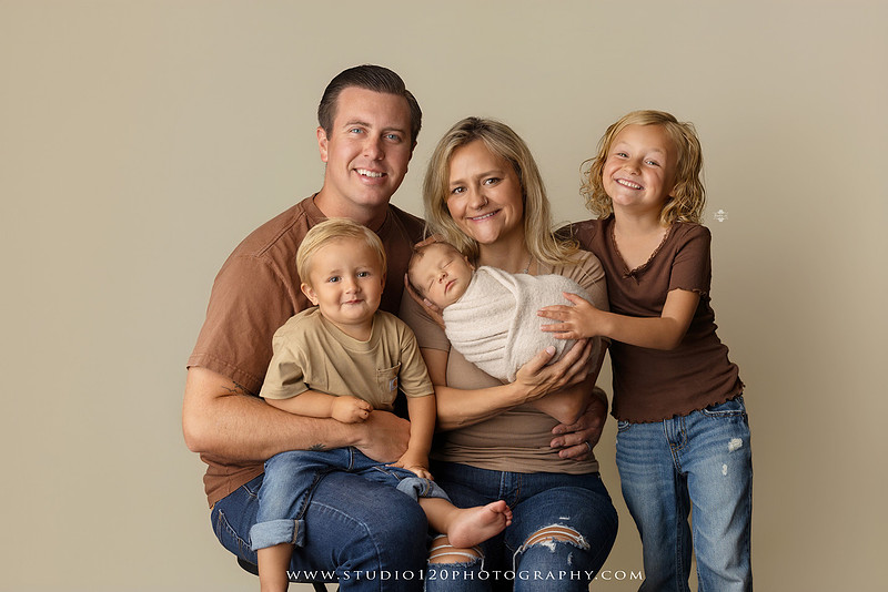 Professional newborn photography session in Ramona featuring a sleeping baby boy, sibling portraits, loving family photos, timeless neutral styling, wrapped newborn poses, and classic studio portraits by Studio 120 Photography.