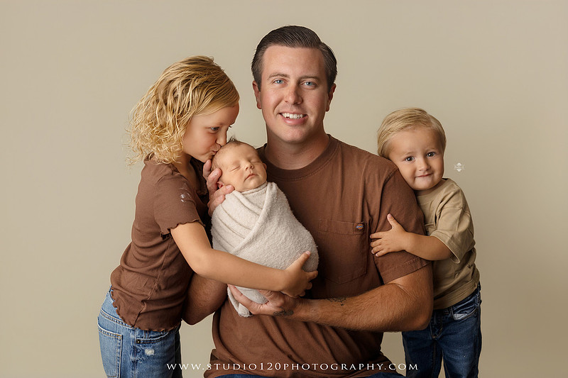 Professional newborn photography session in Ramona featuring a sleeping baby boy, sibling portraits, loving family photos, timeless neutral styling, wrapped newborn poses, and classic studio portraits by Studio 120 Photography.