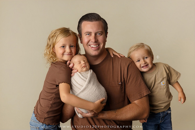 Professional newborn photography session in Ramona featuring a sleeping baby boy, sibling portraits, loving family photos, timeless neutral styling, wrapped newborn poses, and classic studio portraits by Studio 120 Photography.