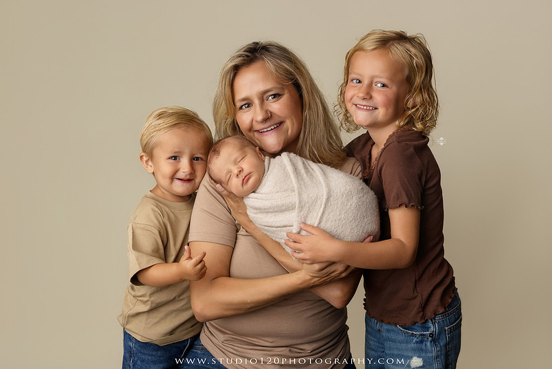Professional newborn photography session in Ramona featuring a sleeping baby boy, sibling portraits, loving family photos, timeless neutral styling, wrapped newborn poses, and classic studio portraits by Studio 120 Photography.
