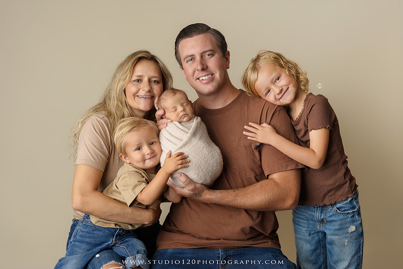 Professional newborn photography session in Ramona featuring a sleeping baby boy, sibling portraits, loving family photos, timeless neutral styling, wrapped newborn poses, and classic studio portraits by Studio 120 Photography.