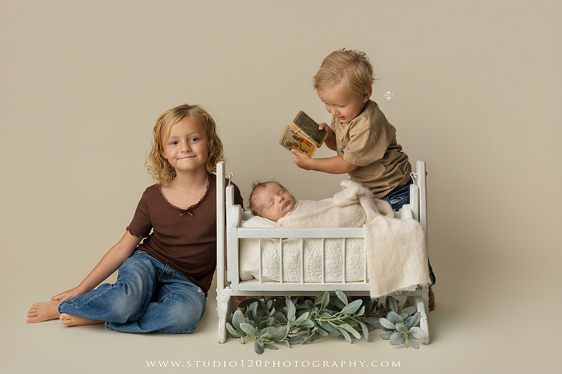 Professional newborn photography session in Ramona featuring a sleeping baby boy, sibling portraits, loving family photos, timeless neutral styling, wrapped newborn poses, and classic studio portraits by Studio 120 Photography.