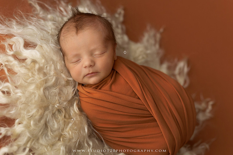 Professional newborn photography session in Ramona featuring a sleeping baby boy, sibling portraits, loving family photos, timeless neutral styling, wrapped newborn poses, and classic studio portraits by Studio 120 Photography.