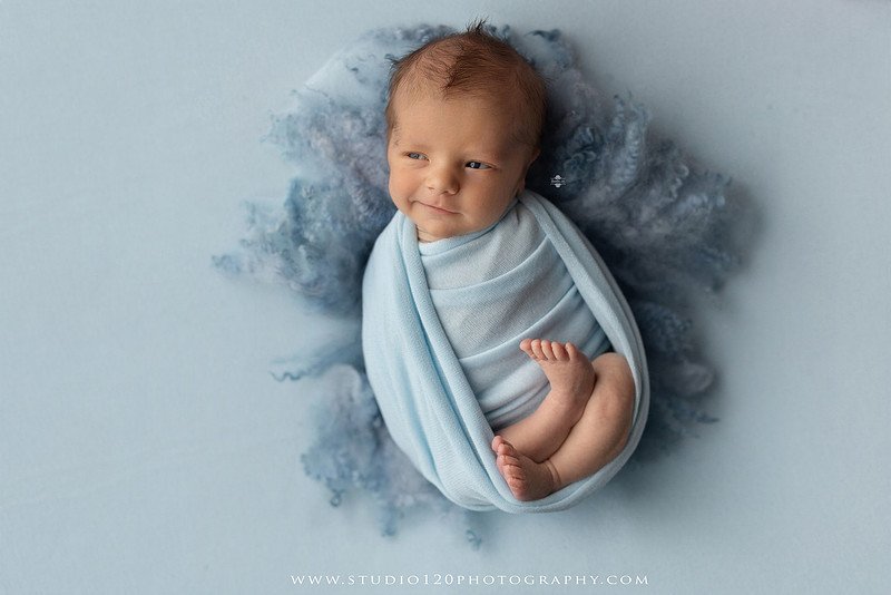 Professional newborn photography session in Ramona featuring a sleeping baby boy, sibling portraits, loving family photos, timeless neutral styling, wrapped newborn poses, and classic studio portraits by Studio 120 Photography.