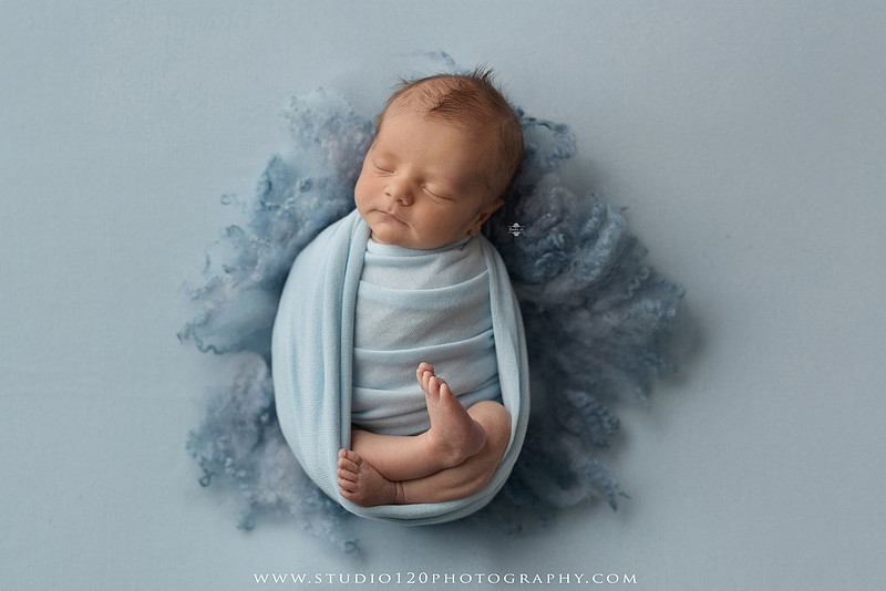 Professional newborn photography session in Ramona featuring a sleeping baby boy, sibling portraits, loving family photos, timeless neutral styling, wrapped newborn poses, and classic studio portraits by Studio 120 Photography.