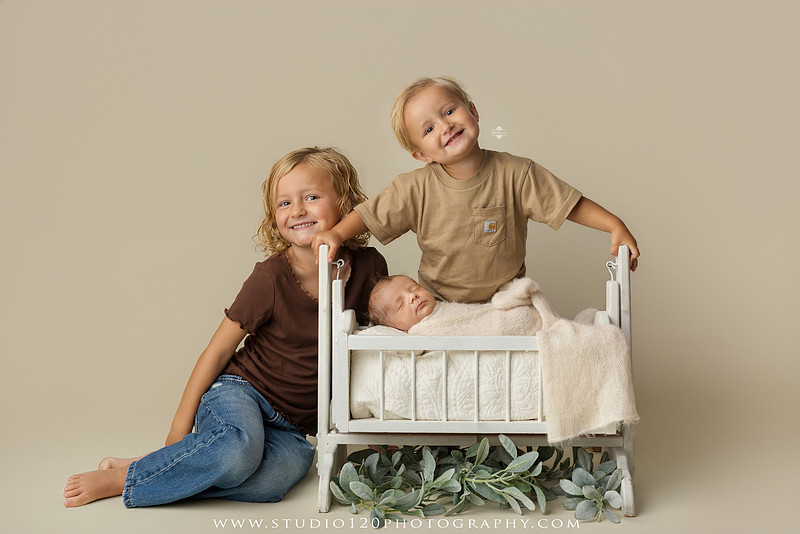 Professional newborn photography session in Ramona featuring a sleeping baby boy, sibling portraits, loving family photos, timeless neutral styling, wrapped newborn poses, and classic studio portraits by Studio 120 Photography.