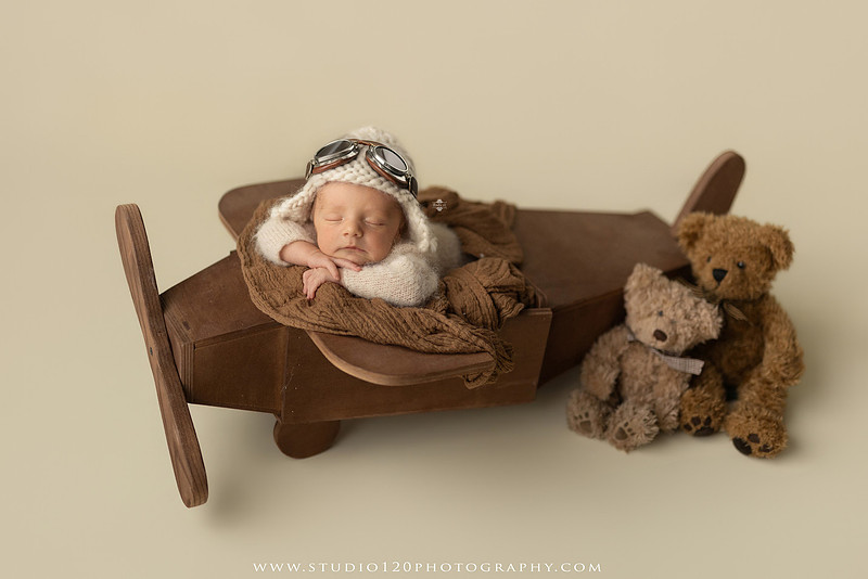 Professional newborn photography session in Ramona featuring a sleeping baby boy, sibling portraits, loving family photos, timeless neutral styling, wrapped newborn poses, and classic studio portraits by Studio 120 Photography.