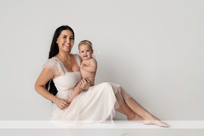 Professional milestone photography session in Ramona featuring a smiling baby girl, mother and baby portraits, classic sitter milestone photos, timeless neutral styling, and first year baby photography by Studio 120 Photography.