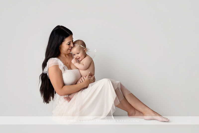 Professional milestone photography session in Ramona featuring a smiling baby girl, mother and baby portraits, classic sitter milestone photos, timeless neutral styling, and first year baby photography by Studio 120 Photography.