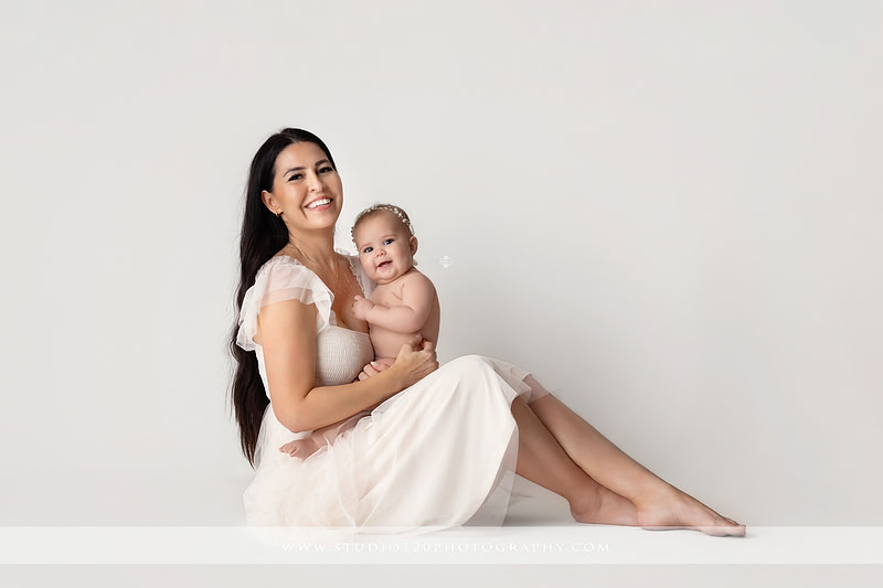 Professional milestone photography session in Ramona featuring a smiling baby girl, mother and baby portraits, classic sitter milestone photos, timeless neutral styling, and first year baby photography by Studio 120 Photography.