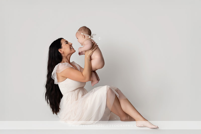 Professional milestone photography session in Ramona featuring a smiling baby girl, mother and baby portraits, classic sitter milestone photos, timeless neutral styling, and first year baby photography by Studio 120 Photography.