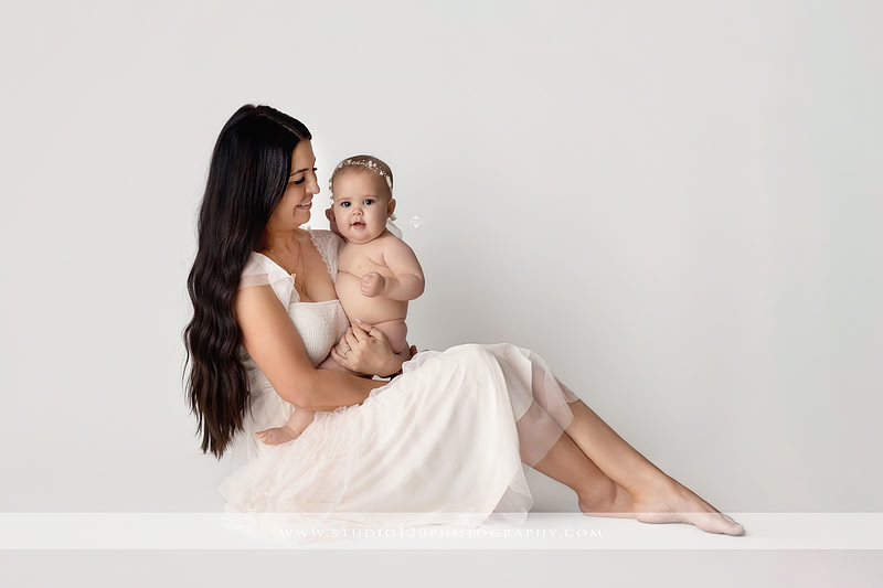 Professional milestone photography session in Ramona featuring a smiling baby girl, mother and baby portraits, classic sitter milestone photos, timeless neutral styling, and first year baby photography by Studio 120 Photography.