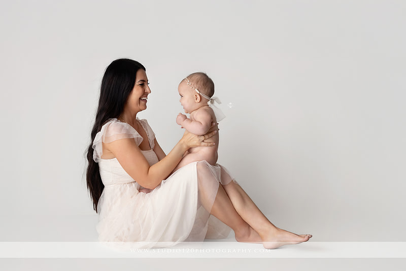 Professional milestone photography session in Ramona featuring a smiling baby girl, mother and baby portraits, classic sitter milestone photos, timeless neutral styling, and first year baby photography by Studio 120 Photography.