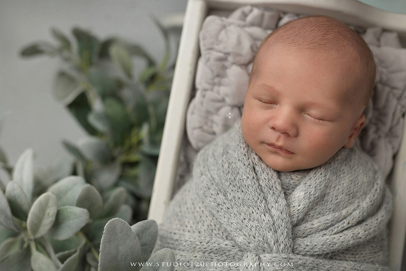 Professional newborn photography session in Ramona featuring a sleeping baby boy, sibling and family portraits, timeless wrapped newborn poses, custom racing-themed portraits, and classic studio photography by Studio 120 Photography.