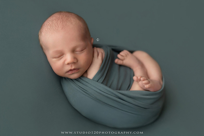 Professional newborn photography session in Ramona featuring a sleeping baby boy, sibling and family portraits, timeless wrapped newborn poses, custom racing-themed portraits, and classic studio photography by Studio 120 Photography.
