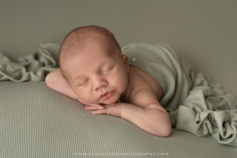 Professional newborn photography session in Ramona featuring a sleeping baby boy, sibling and family portraits, timeless wrapped newborn poses, custom racing-themed portraits, and classic studio photography by Studio 120 Photography.