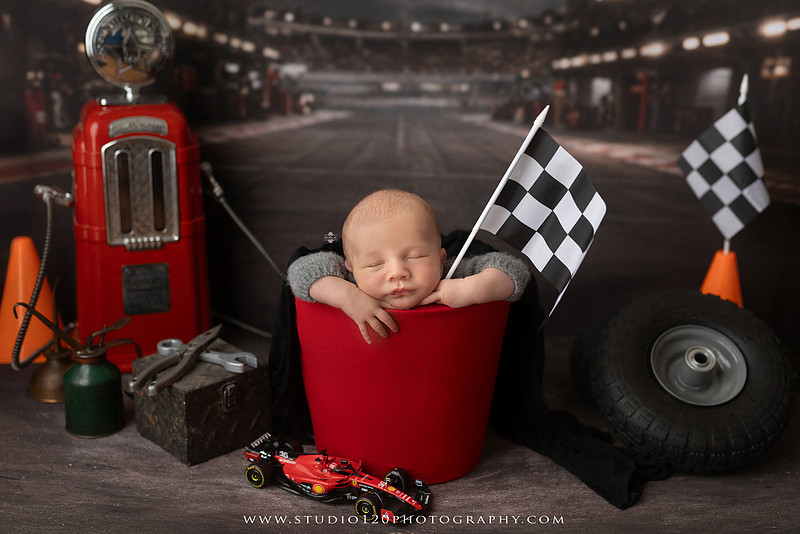 Professional newborn photography session in Ramona featuring a sleeping baby boy, sibling and family portraits, timeless wrapped newborn poses, custom racing-themed portraits, and classic studio photography by Studio 120 Photography.
