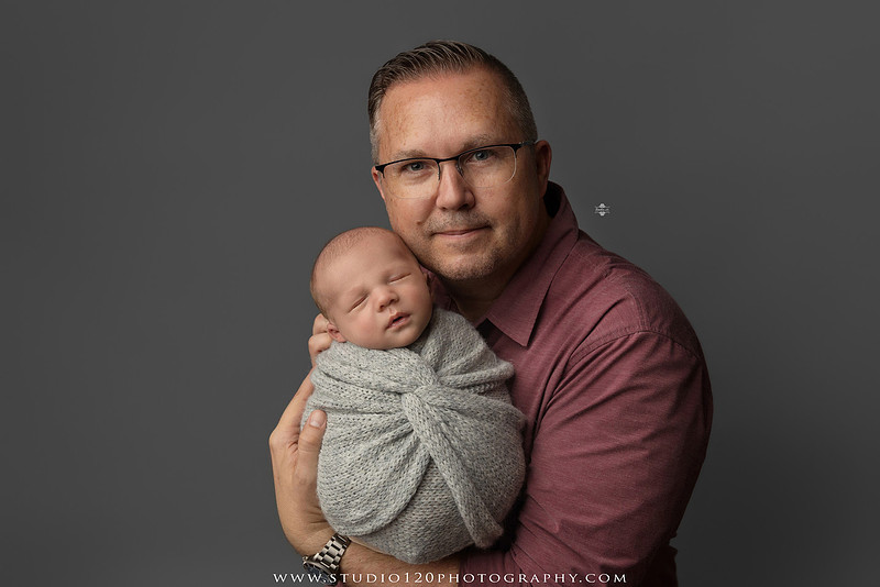 Professional newborn photography session in Ramona featuring a sleeping baby boy, sibling and family portraits, timeless wrapped newborn poses, custom racing-themed portraits, and classic studio photography by Studio 120 Photography.