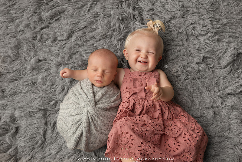 Professional newborn photography session in Ramona featuring a sleeping baby boy, sibling and family portraits, timeless wrapped newborn poses, custom racing-themed portraits, and classic studio photography by Studio 120 Photography.