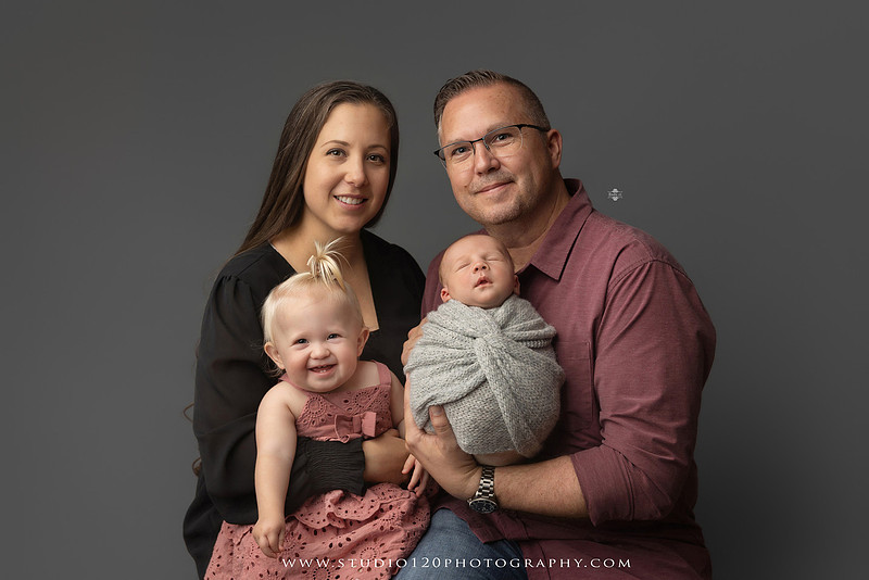Professional newborn photography session in Ramona featuring a sleeping baby boy, sibling and family portraits, timeless wrapped newborn poses, custom racing-themed portraits, and classic studio photography by Studio 120 Photography.