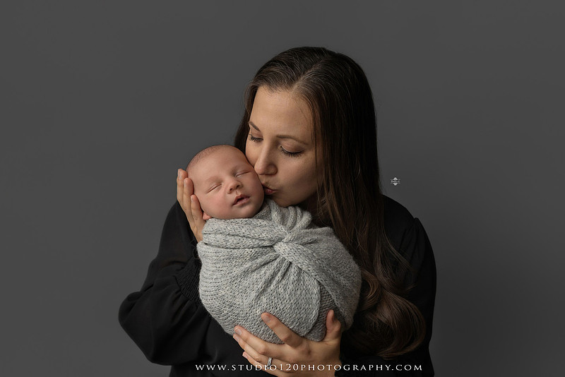 Professional newborn photography session in Ramona featuring a sleeping baby boy, sibling and family portraits, timeless wrapped newborn poses, custom racing-themed portraits, and classic studio photography by Studio 120 Photography.
