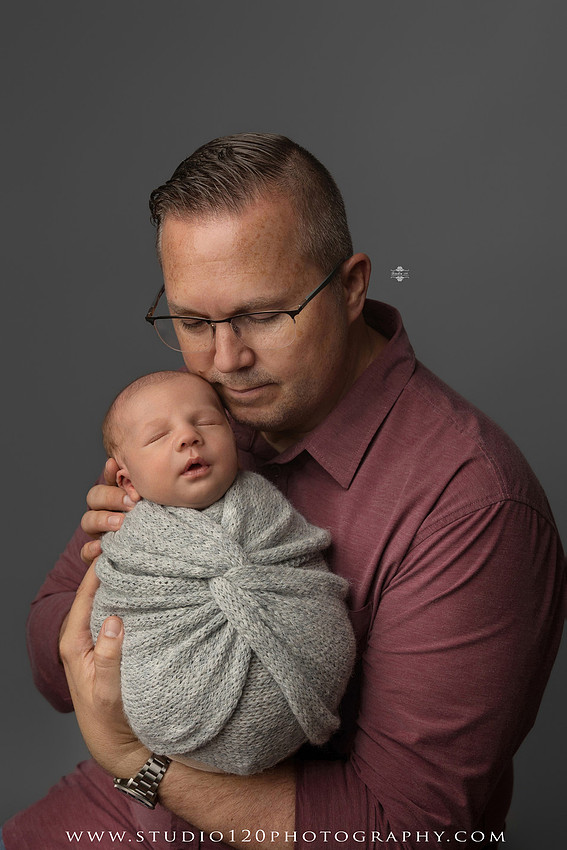 Professional newborn photography session in Ramona featuring a sleeping baby boy, sibling and family portraits, timeless wrapped newborn poses, custom racing-themed portraits, and classic studio photography by Studio 120 Photography.
