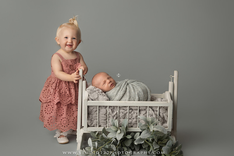 Professional newborn photography session in Ramona featuring a sleeping baby boy, sibling and family portraits, timeless wrapped newborn poses, custom racing-themed portraits, and classic studio photography by Studio 120 Photography.