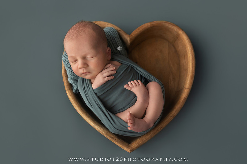 Professional newborn photography session in Ramona featuring a sleeping baby boy, sibling and family portraits, timeless wrapped newborn poses, custom racing-themed portraits, and classic studio photography by Studio 120 Photography.