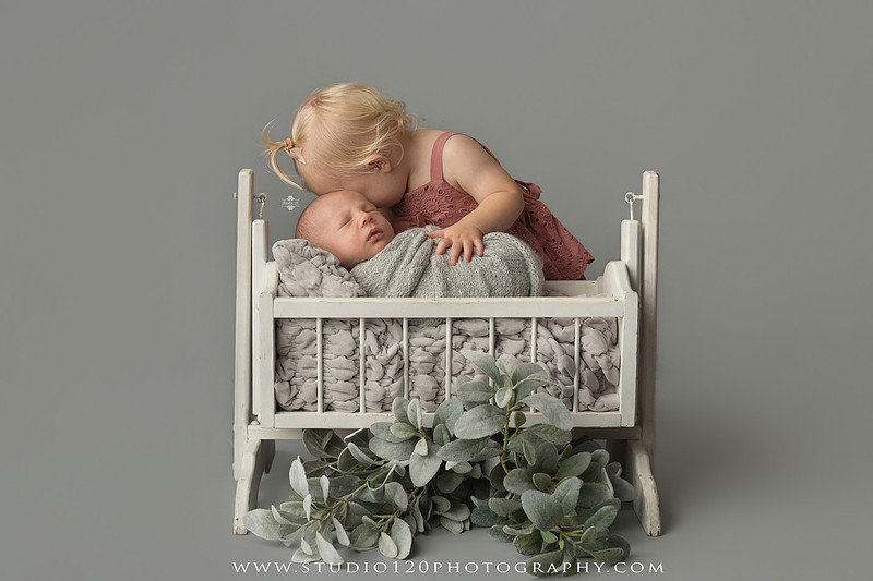 Professional newborn photography session in Ramona featuring a sleeping baby boy, sibling and family portraits, timeless wrapped newborn poses, custom racing-themed portraits, and classic studio photography by Studio 120 Photography.