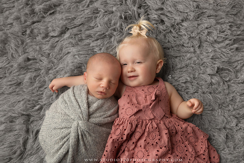 Professional newborn photography session in Ramona featuring a sleeping baby boy, sibling and family portraits, timeless wrapped newborn poses, custom racing-themed portraits, and classic studio photography by Studio 120 Photography.