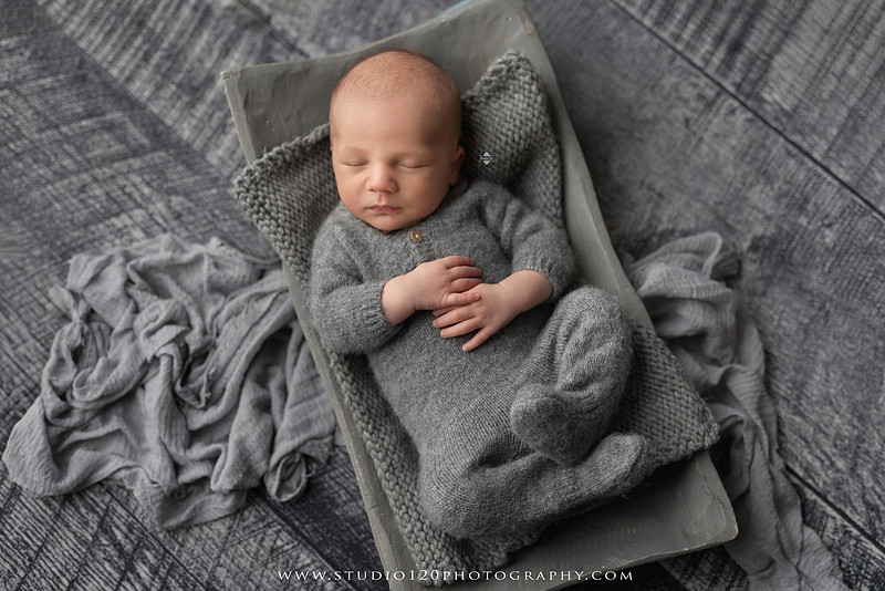 Professional newborn photography session in Ramona featuring a sleeping baby boy, sibling and family portraits, timeless wrapped newborn poses, custom racing-themed portraits, and classic studio photography by Studio 120 Photography.