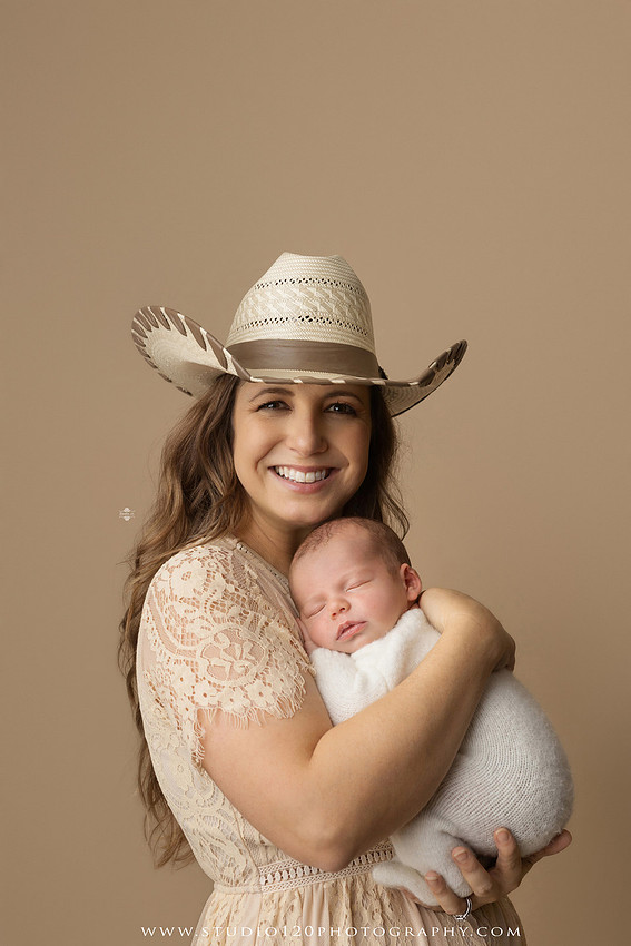 SOTP5913 copyProfessional newborn photography session featuring a sleeping baby boy in rustic western-inspired setups with cowboy hats, neutral wraps, wooden props, greenery, and vintage accents, along with heartfelt family portraits with parents and their dogs at Studio 120 Photography in Ramona, California.