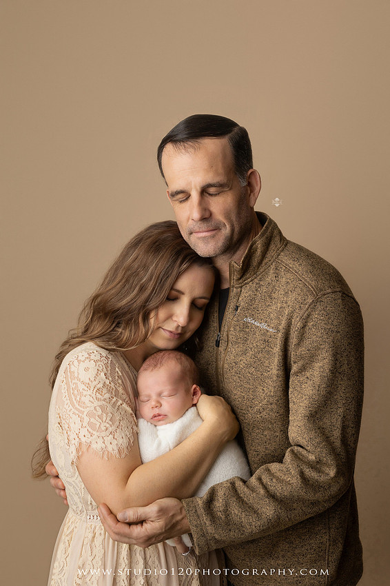 SOTP5913 copyProfessional newborn photography session featuring a sleeping baby boy in rustic western-inspired setups with cowboy hats, neutral wraps, wooden props, greenery, and vintage accents, along with heartfelt family portraits with parents and their dogs at Studio 120 Photography in Ramona, California.