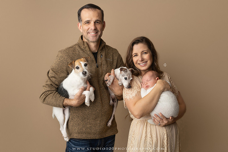 SOTP5913 copyProfessional newborn photography session featuring a sleeping baby boy in rustic western-inspired setups with cowboy hats, neutral wraps, wooden props, greenery, and vintage accents, along with heartfelt family portraits with parents and their dogs at Studio 120 Photography in Ramona, California.